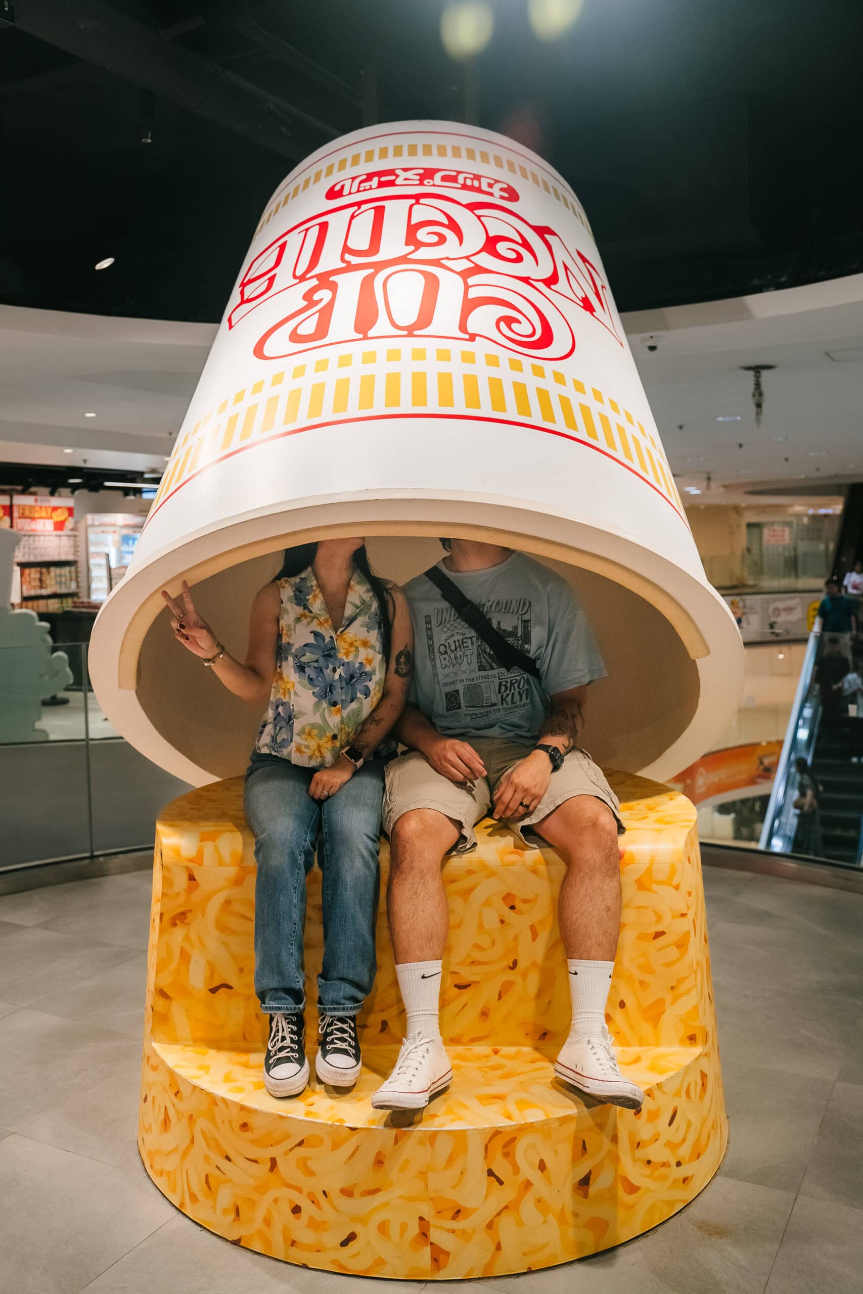 Bucket hat with P.F. Chang's logo and text at a shopping mall or food court in the US.