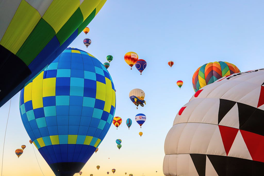 A vibrant display of hot air balloons soaring at dawn in Albuquerque, New Mexico.