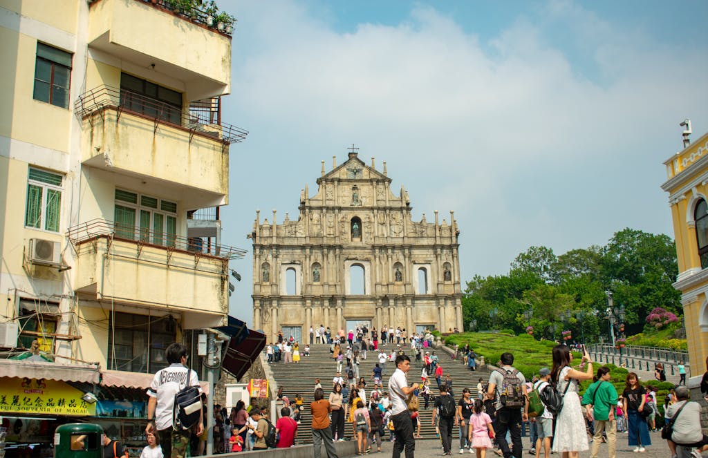 Busy tourist attraction at the historic Ruins of St. Paul in Macau, showcasing baroque architecture.